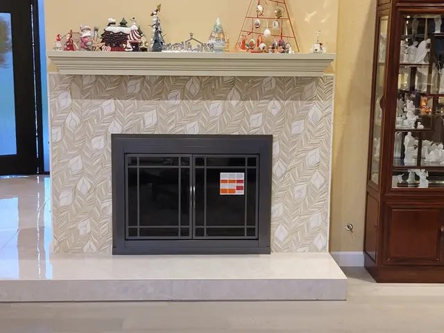 Finished fireplace in Alamo with a patterned stone face, new mantel and black fireplace doors