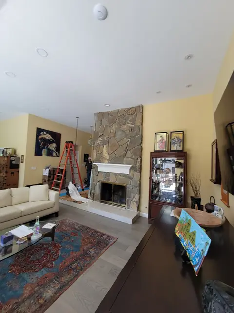 The Alamo living room and original stone fireplace before the remodel
