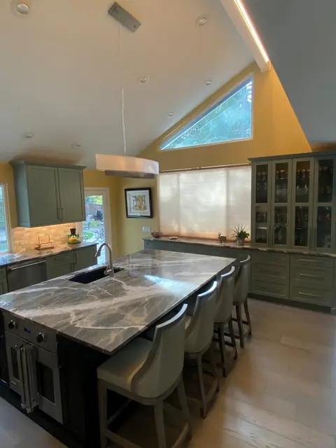 Island seating and glass-front cabinets in the Alamo kitchen remodel