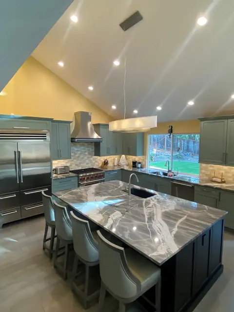 Alamo kitchen remodel, island and stainless refrigerator under a vaulted ceiling