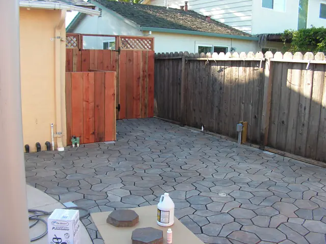 New stone pavers in a Dublin back yard with a wood fence