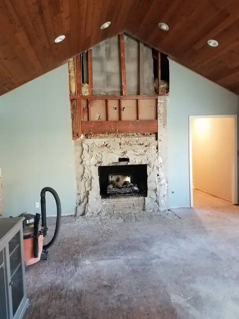 Fireplace stripped back to the framing before refacing