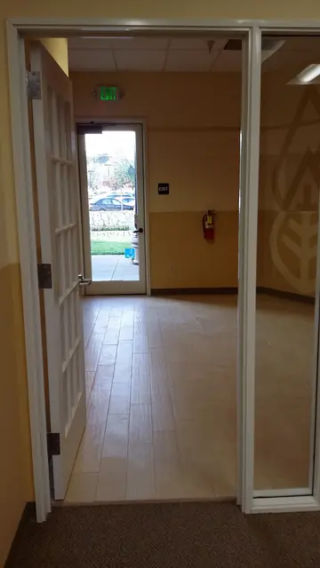 After: finished hallway with new flooring leading to the rear door, Huntington Learning Center, Danville