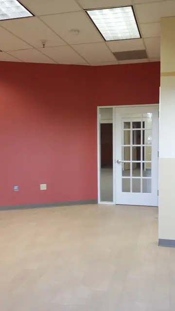 After: red-walled room with French doors and new flooring at Huntington Learning Center in Danville