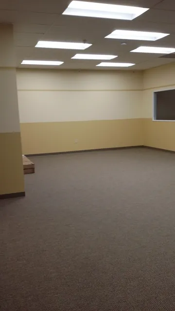 After: a finished carpeted classroom with an interior window at Huntington Learning Center in Danville