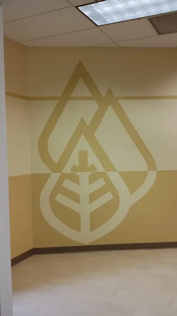 After: the Huntington leaf logo painted on a finished wall in Danville