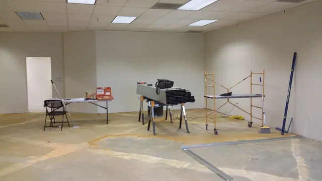 Before: the empty Danville tenant space during demolition, with tools and scaffolding on a bare floor