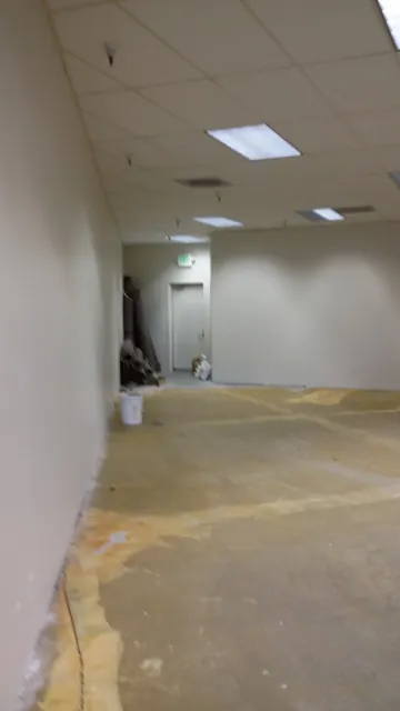 Before: bare walls and stripped floor along one side of the Danville space