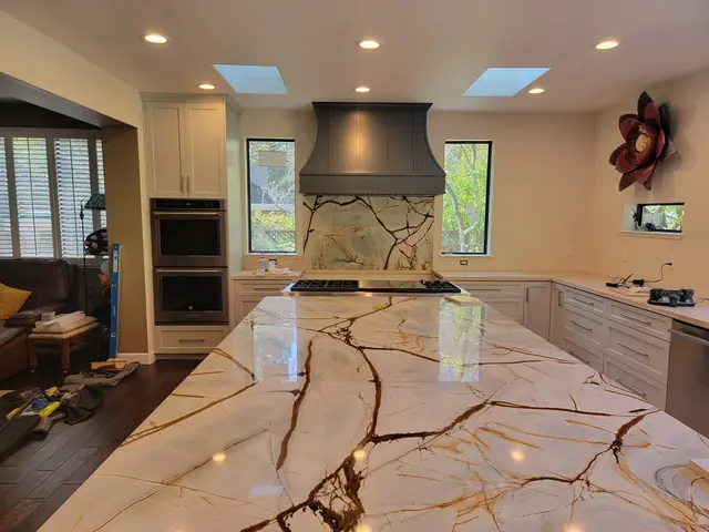 Range hood and veined island in the remodeled kitchen