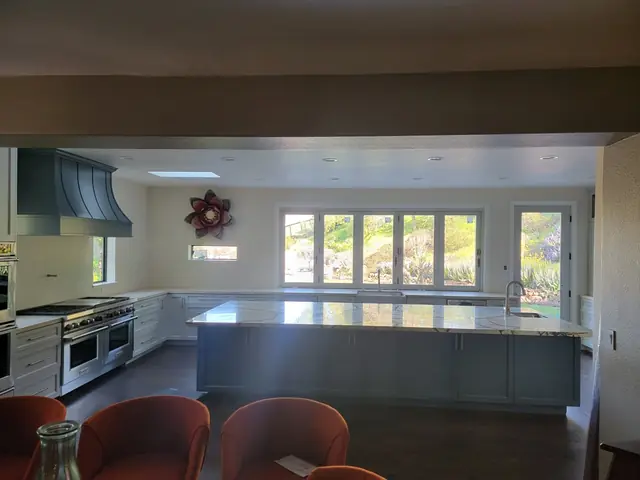 Remodeled kitchen seen from the family room, island and range wall