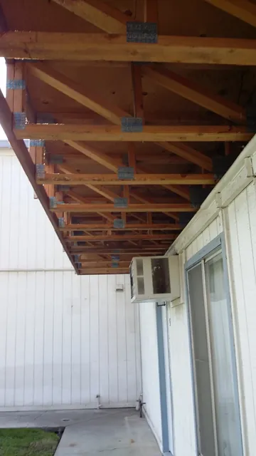 In progress: new walkway framing with metal joist hangers under the Manteca apartment balcony