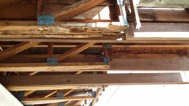 In progress: new joists and metal hangers beside old framing under the Manteca walkway