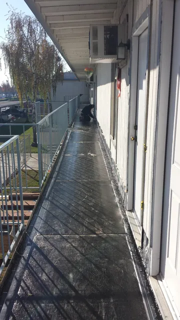 In progress: base coat along the full length of the Manteca apartment walkway