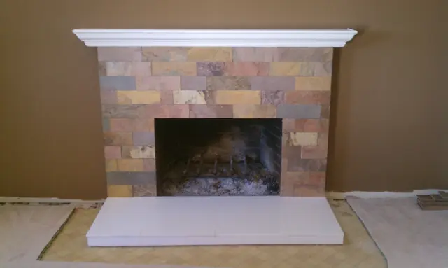 Renovated Pleasanton fireplace with a slate tile face, white mantel and new hearth
