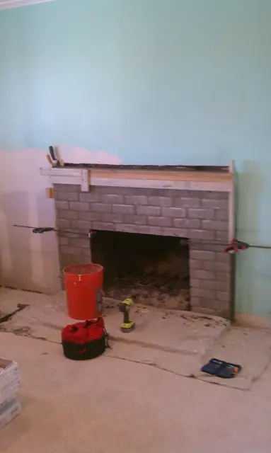 The Pleasanton fireplace before renovation, original brick exposed