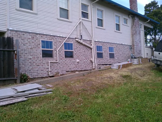 Finished faux brick siding on an older home in Rio Vista, matching the original chimney