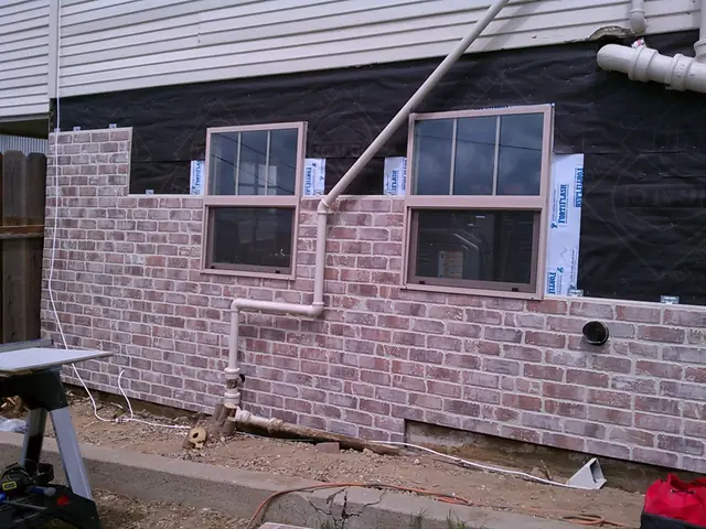 Faux brick siding going up around the windows in Rio Vista