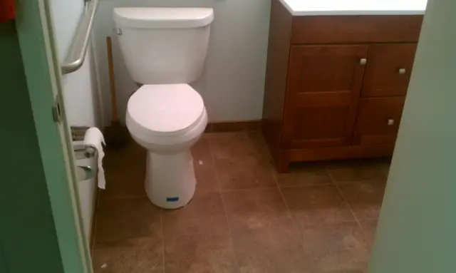 Remodeled restroom with a new toilet and wood vanity, San Leandro office tenant improvement