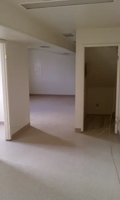 Open office rooms with new flooring in the San Leandro building