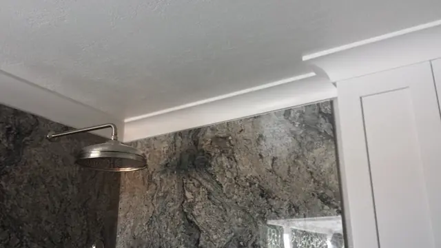 Granite shower wall and white cabinetry in the San Ramon bathroom