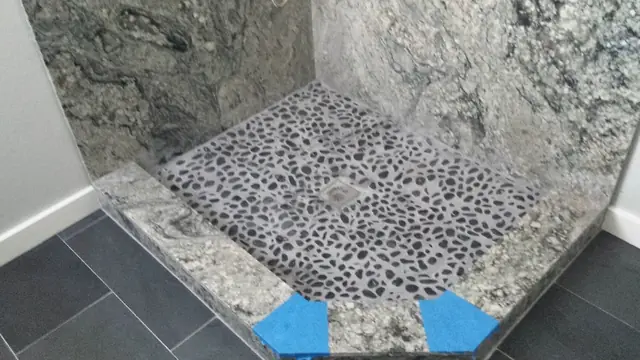 Pebble shower floor and granite curb in the San Ramon bathroom remodel