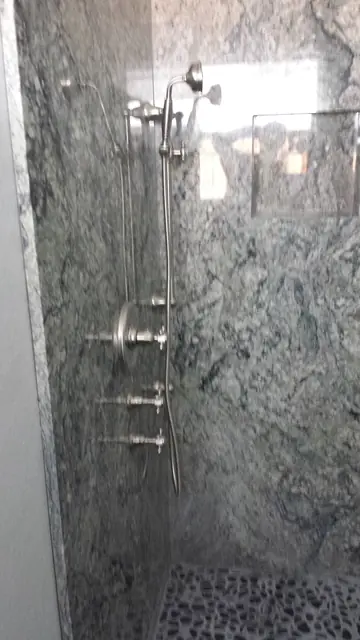 Granite shower walls with new fixtures in the San Ramon bathroom remodel