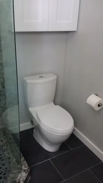 TOTO toilet and natural stone floor in the San Ramon bathroom remodel