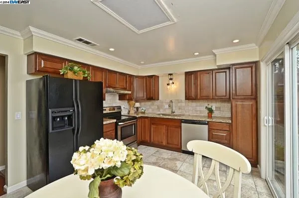 Remodeled kitchen in the San Ramon home with wood cabinets and tile floor