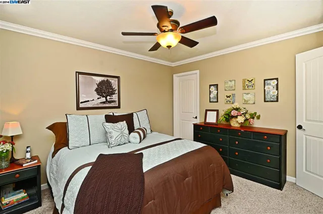 Bedroom in the San Ramon home remodel with a ceiling fan and new paint