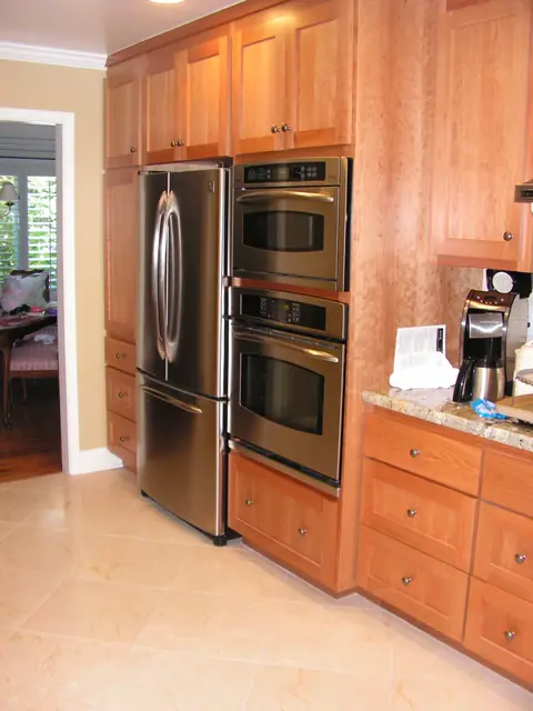 Stainless refrigerator and wall ovens set in hardwood cabinetry, San Ramon